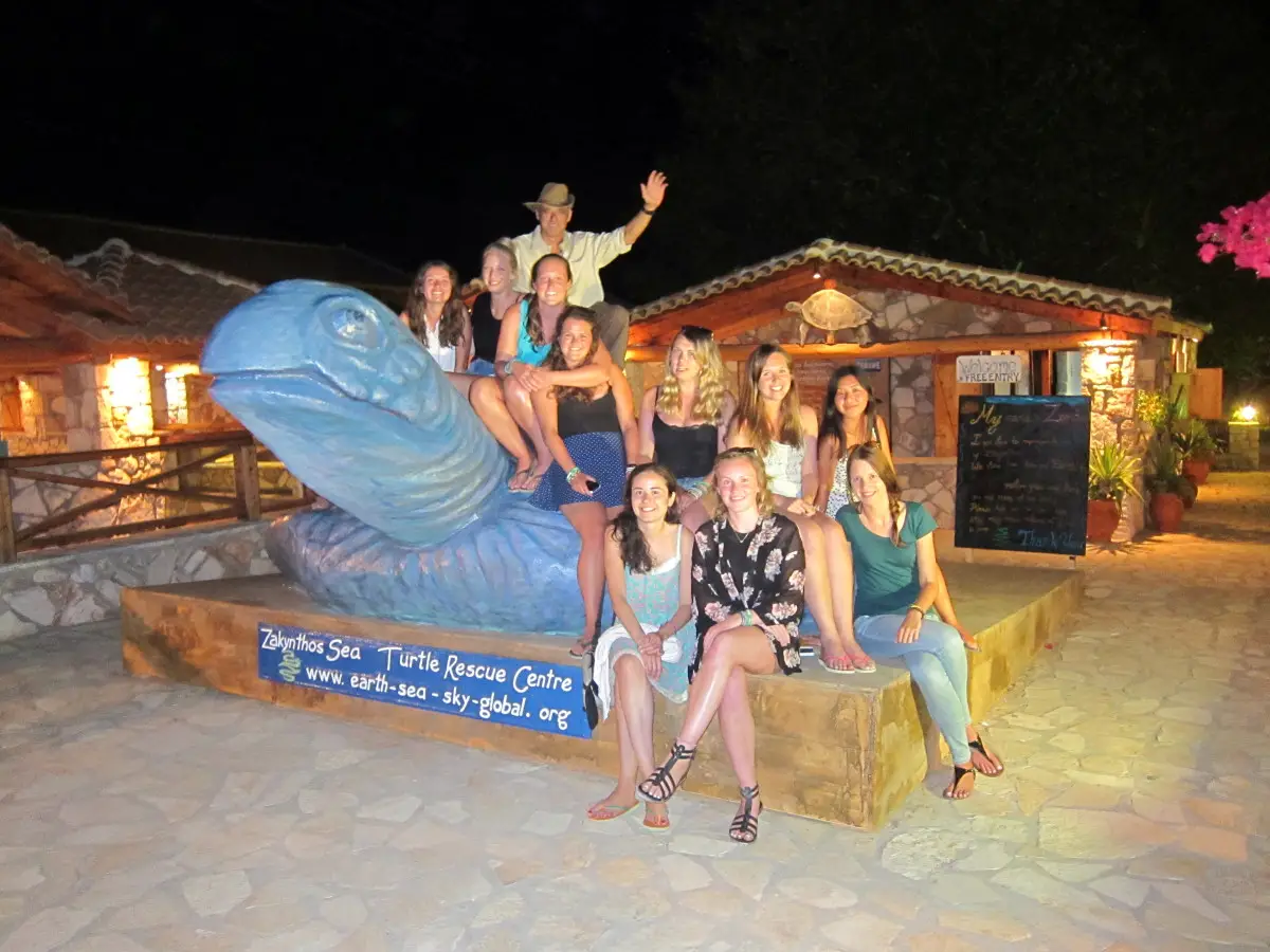 The volunteers taking a photo with founder Yannis on the new sea turtle statue| Laugh Travel Eat