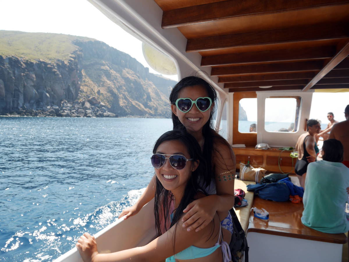 my sister and I happy to be aboard this boat trip to Vulcano | Laugh Travel Eat