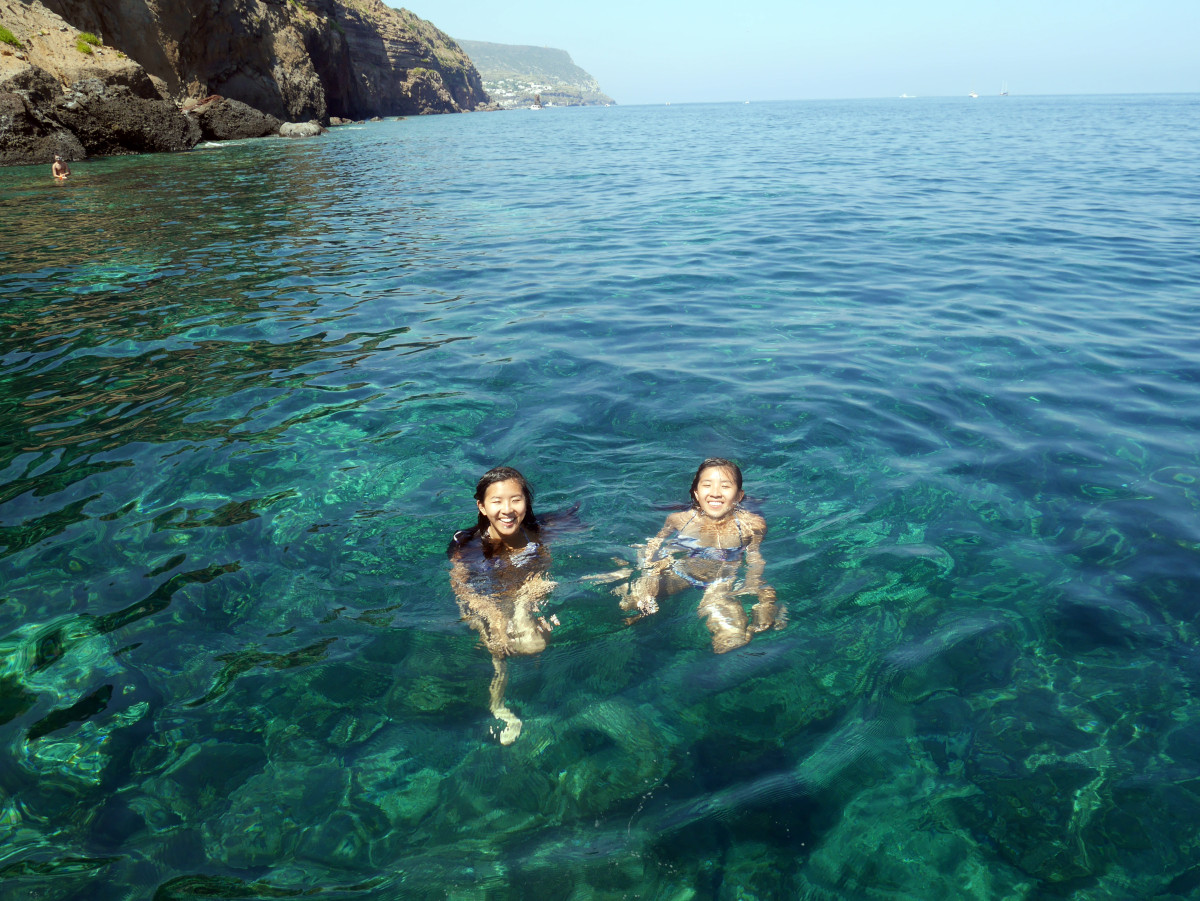 my sister and I swimming in the clear blue water at Lipari| Laugh Travel Eat