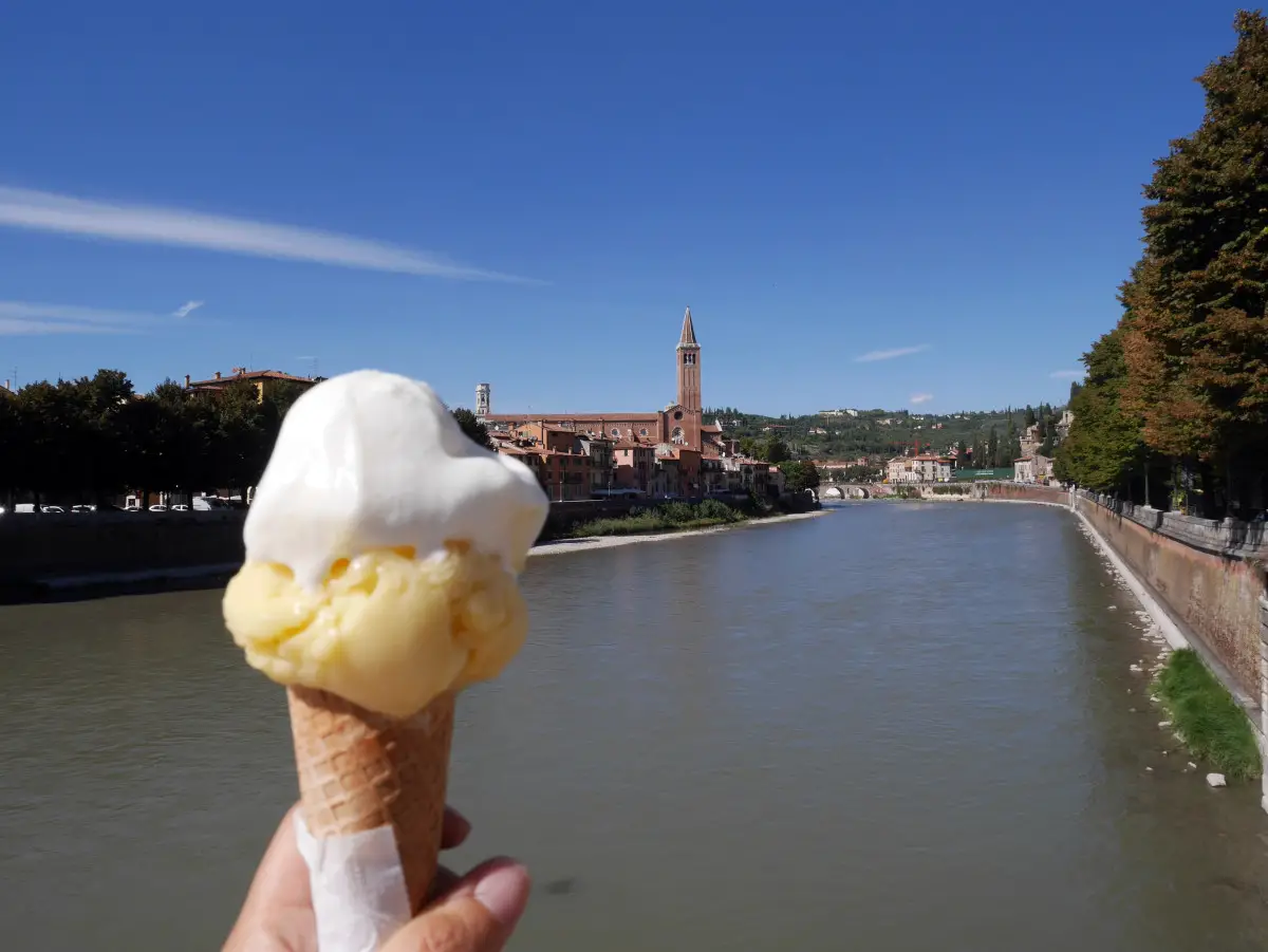 Enjoying the best gelato whilst admiring the view along Verona's river, Ponte Pietra| Laugh Travel Eat