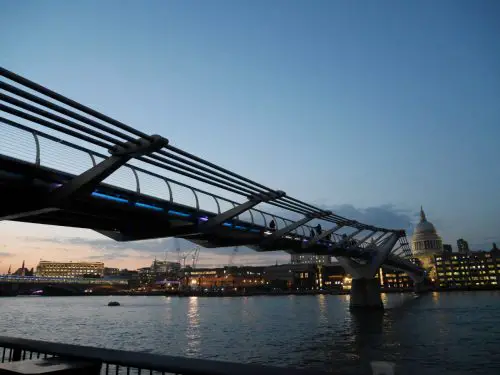 The Millennium Bridge across the River Thames in London at twilight | Laugh Travel Eat