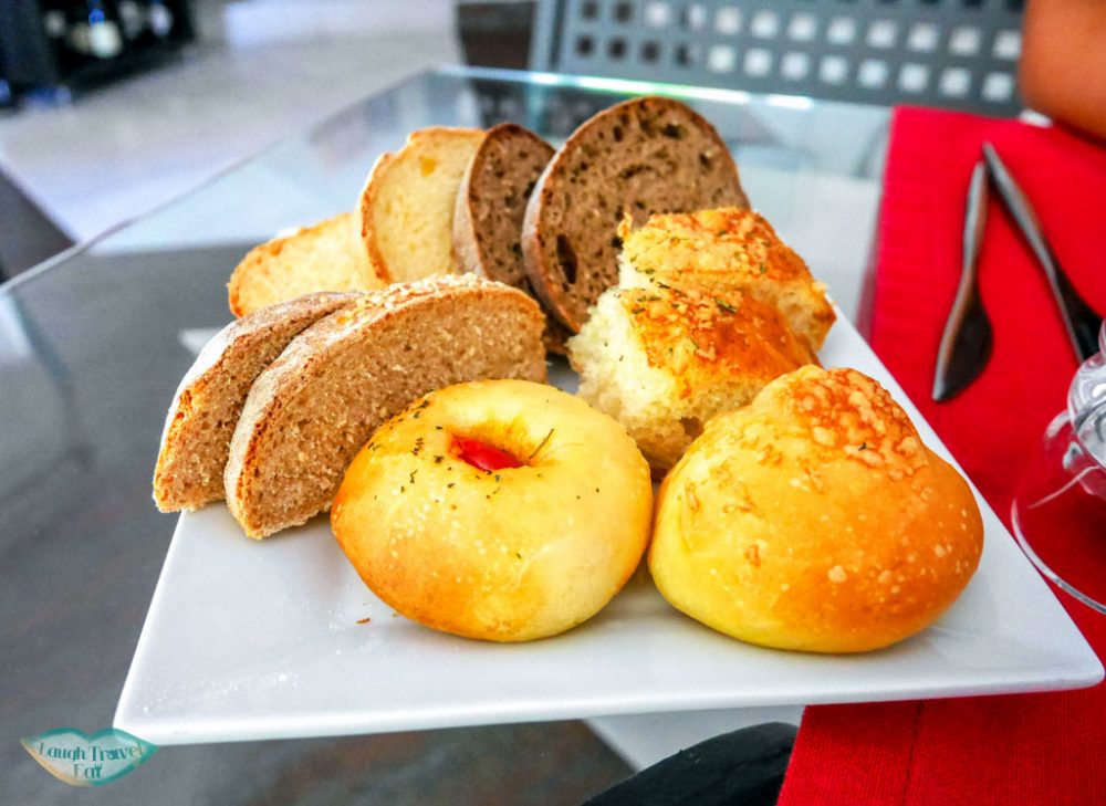 big plate of complimentary mixed bread platter with our meal at Andreas Ristorante, Taormina | Laugh Travel Eat