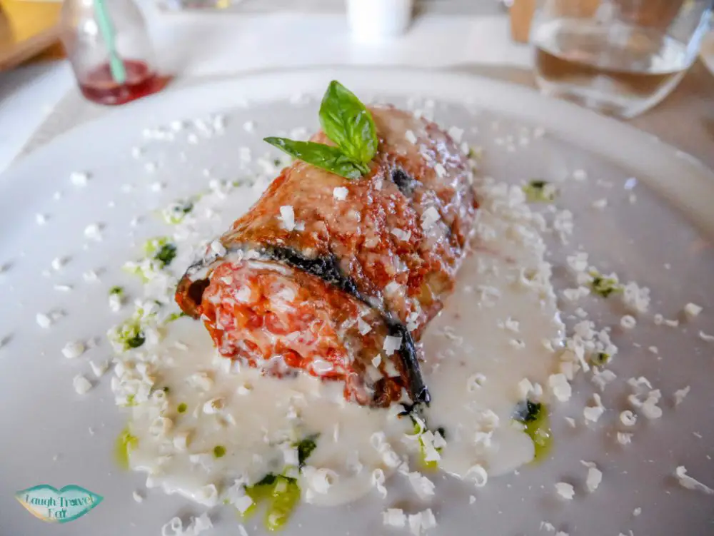 macaroni wrapped in lasagna seated in a pool of cream sauce with cheese shredded on top (yum!) at Flam Osteria at Palermo | Laugh Travel Eat