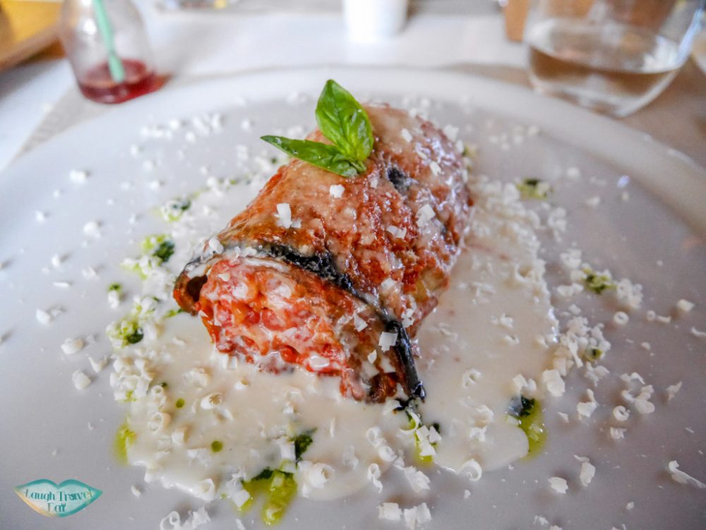 macaroni wrapped in lasagna seated in a pool of cream sauce with cheese shredded on top (yum!) at Flam Osteria at Palermo | Laugh Travel Eat