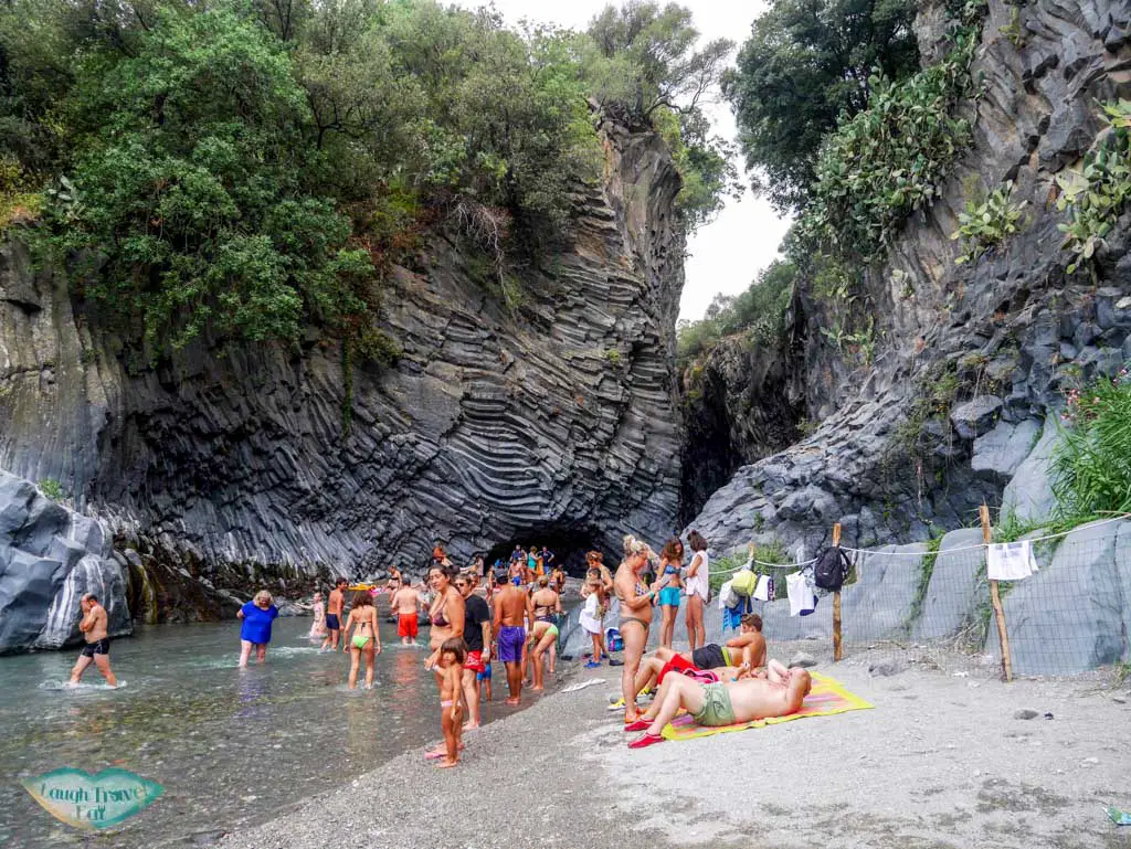 Tourist enjoying their day at the river beach down at the Alicantara river gorge, Catania, Sicily, Italy | Laugh Travel Eat