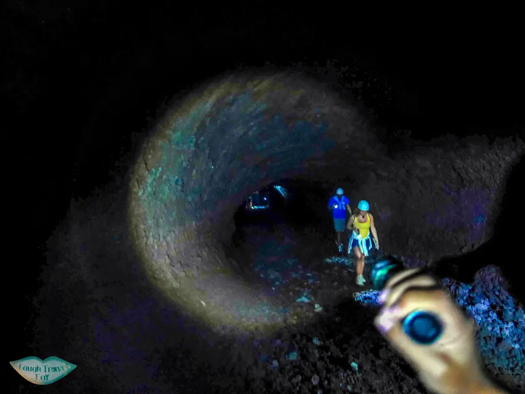 Pitch black interior of lava tube at Mount Etna, illuminated by torch light only, Mount Etna, Catania, Sicily | Laugh Travel Eat
