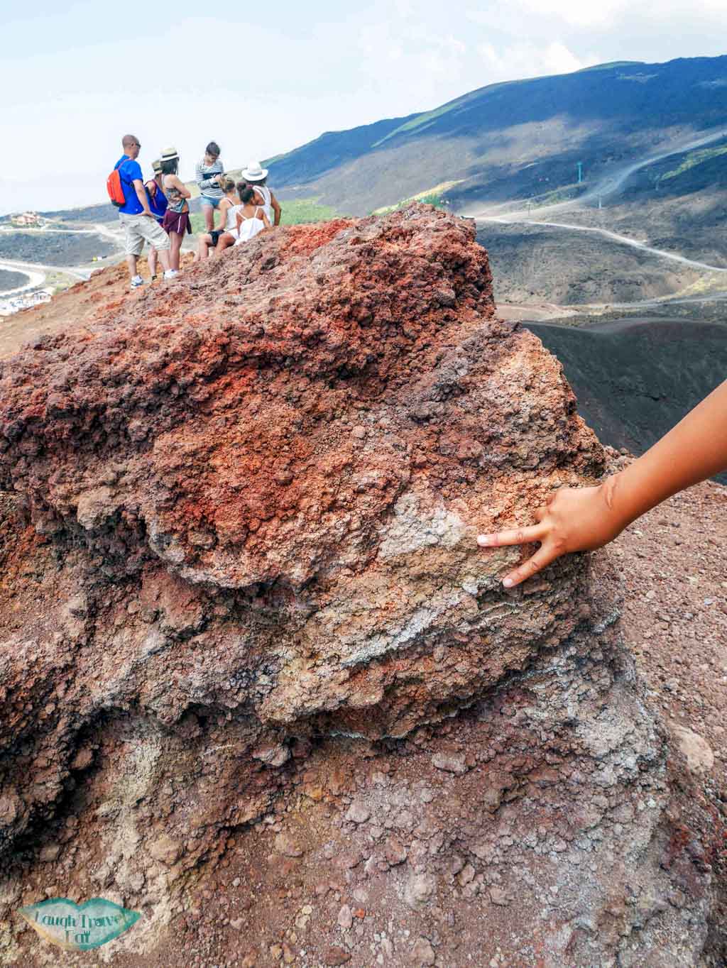 examining the pyroclastic rock by a crater on Mount Etna, Sicily | Laugh Travel Eat
