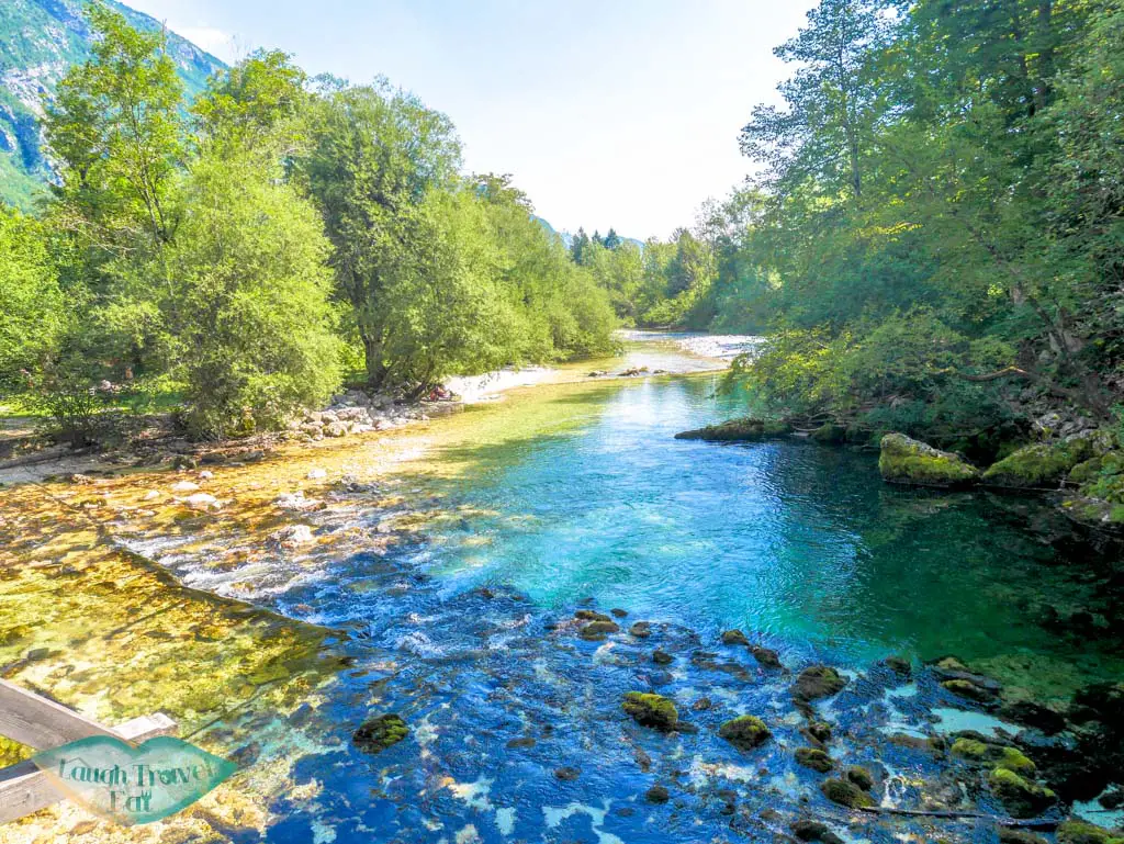 river flowing into lake bohinj slovenia - laugh travel eat