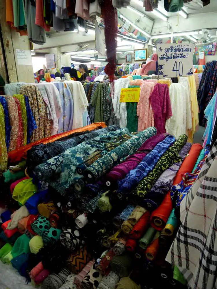 Elephant print and various colourful fabric on sale, Warorot Market, Chiang Mai, Thailand | Laugh Travel Eat