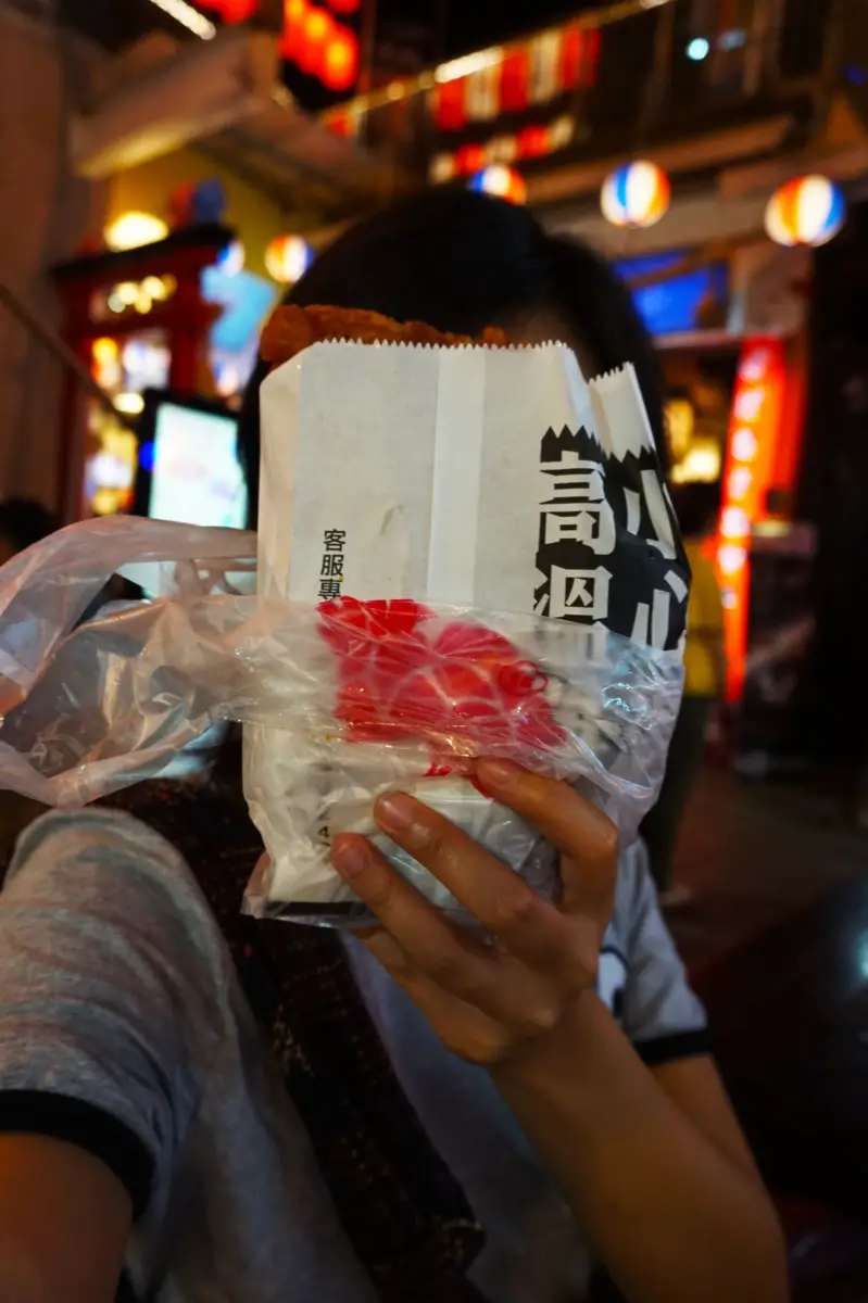 Comparing Devil's Chicken Chop size to my face at FengJia Night Market, Taichung, Taiwan | Laugh Travel Eat