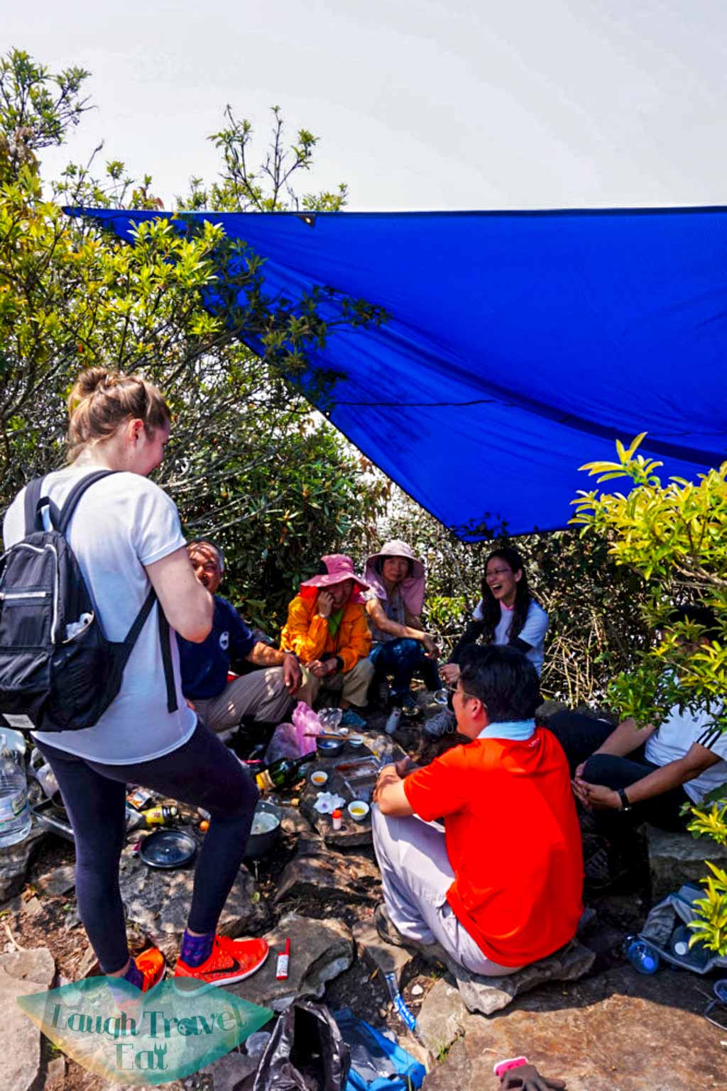 Regular hikers cooking and drinking with a cover set up for shade at Yuan Zui Mountain in Dasyueshan National Forest Recreational Area, Taichung - Laugh Travel Eat