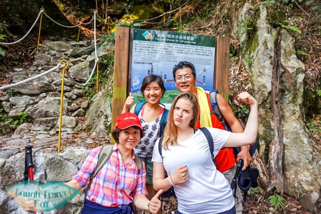 Triumphant pose in front of finishing line after hike up to Yuan Zui Mountain in Dasyueshan National Forest Recreational Area, Taichung - Laugh Travel Eat