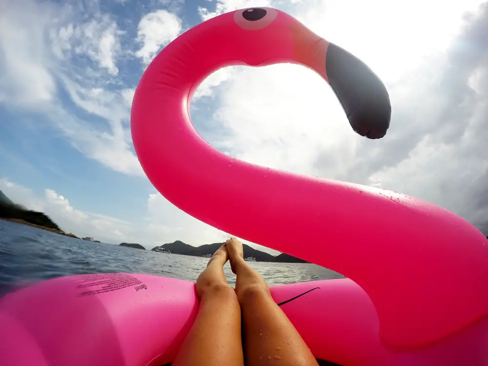 Chilling with flamingo float, The ultimate guide to a Sai Kung Boat Trip in Hong Kong | Laugh Travel Eat