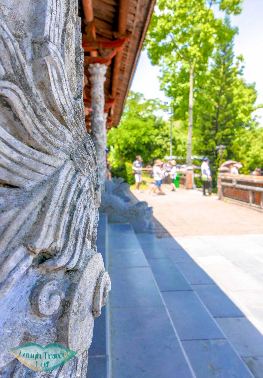 A beautifully carved stone pillar on one of the main buildings left standing, Hue Citadel, Hue, Vietnam - Laugh Travel Eat