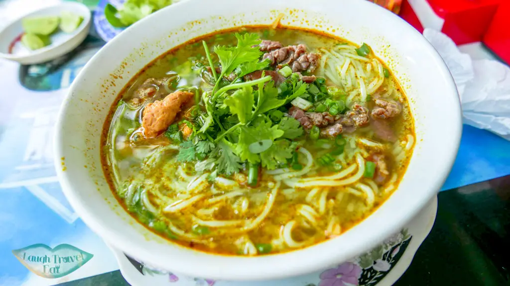 Eating Hue Beef noodles at one of the local stalls off the street, Hue, Vietnam - Laugh Travel Eat