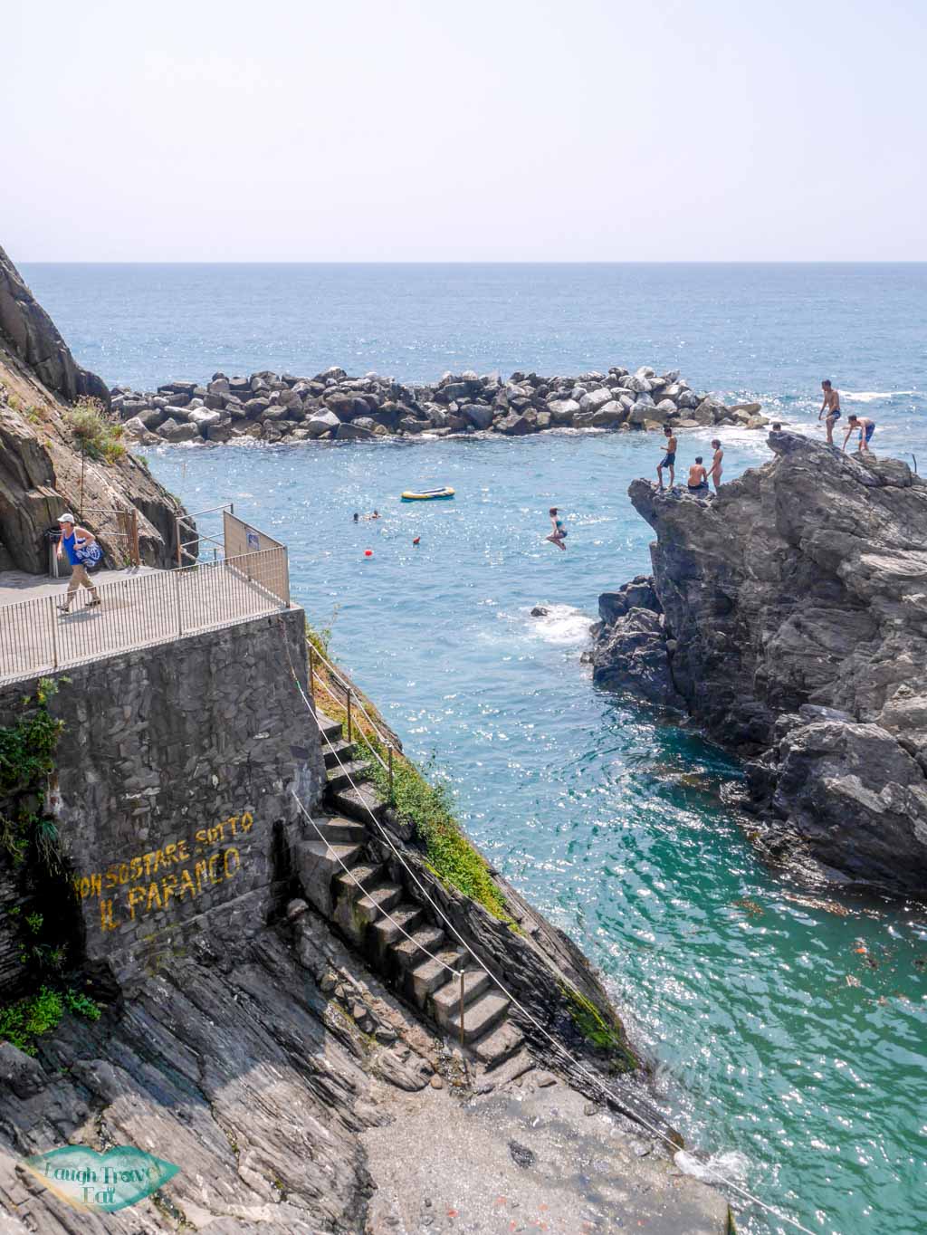 cliff jumping between the narrow strand of sea at Manarola | Laugh Travel Eat