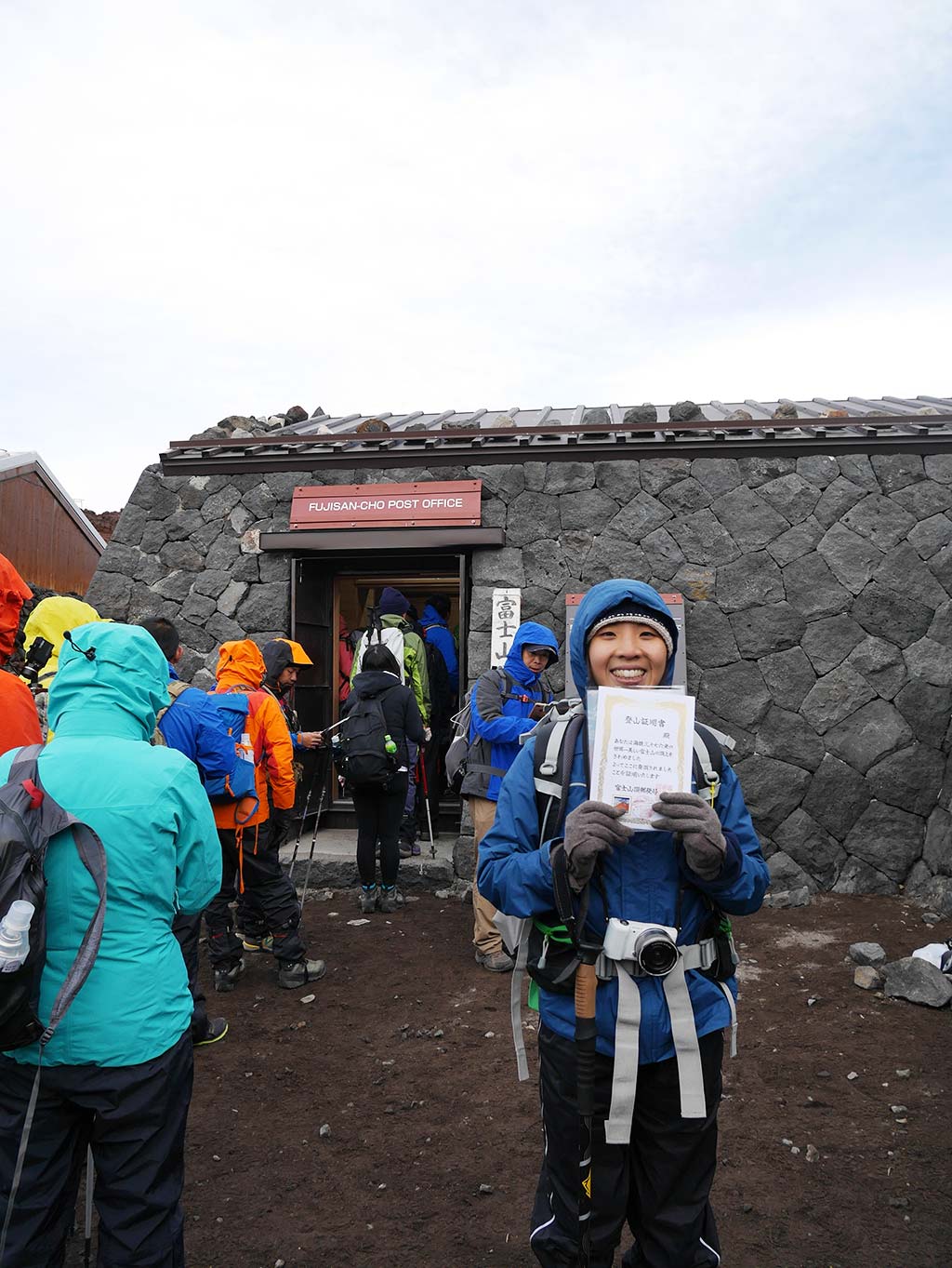 Getting hiking certificate at post office on Mount Fuji summit, Japan | Laugh Travel Eat