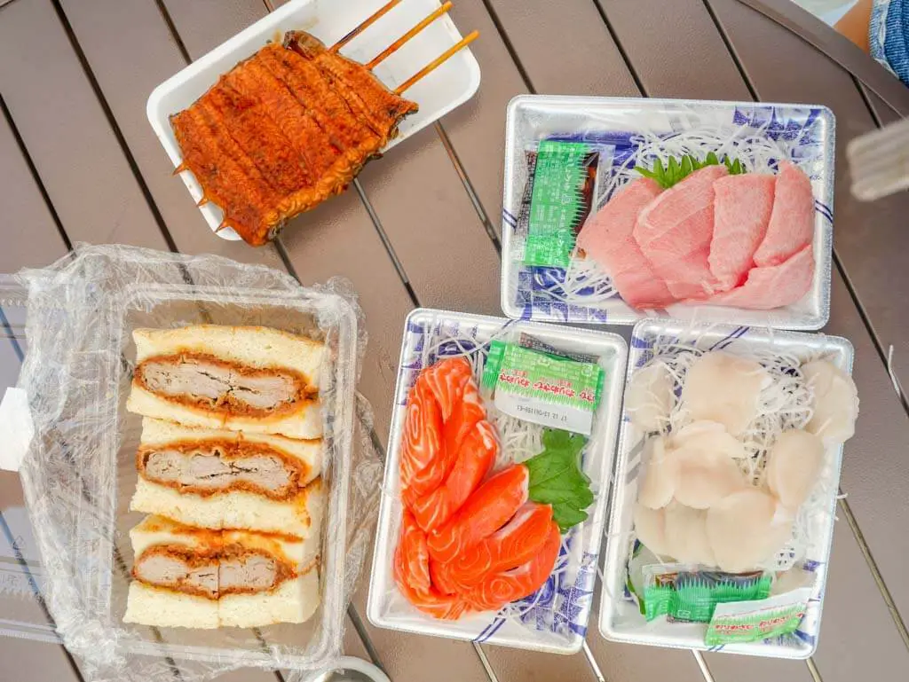 sashimi and pork chop buns at tsukiji fish market tokyo, japan | Laugh Travel Eat