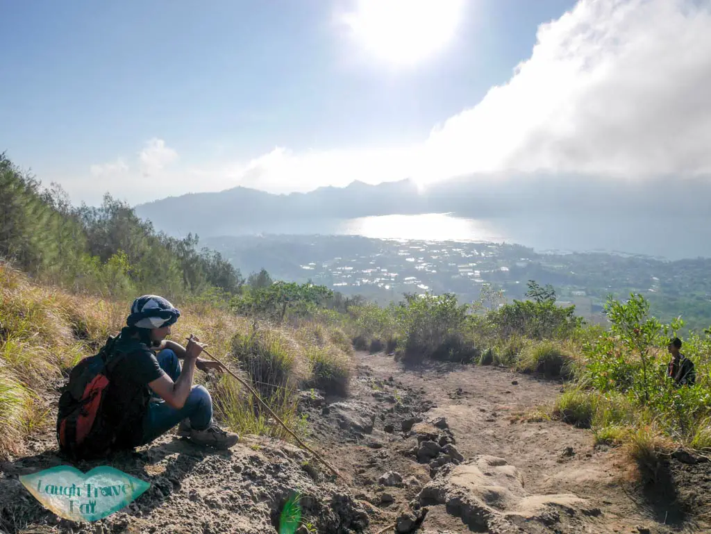 our tour guide going down Mount Batur bali indonesia - laugh travel eat