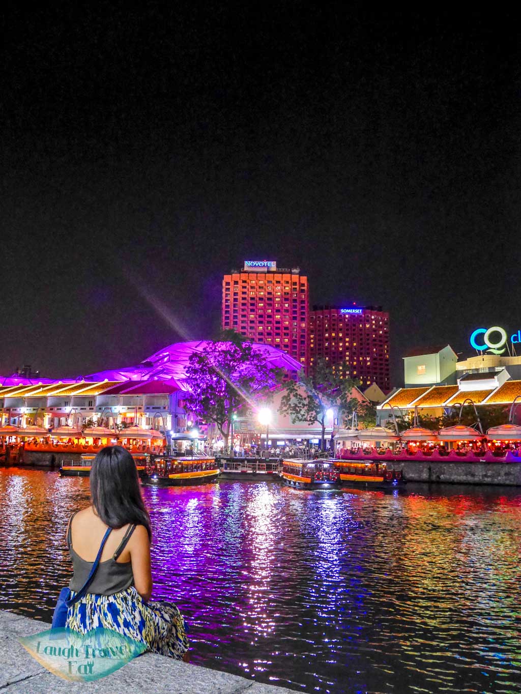 photo of me by a stranger at clarke quay singapore - laugh travel eat