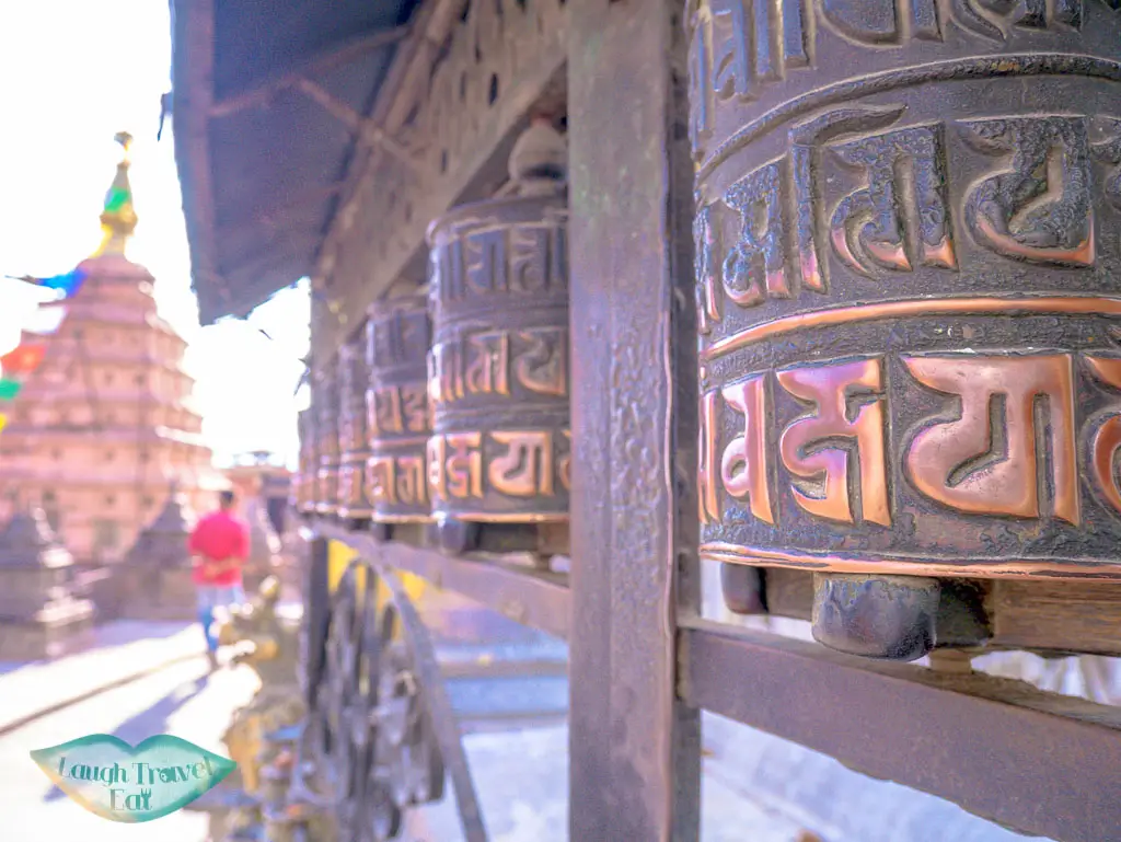 prayer-wheels-at-Swayambhunath-Temple-Kathmandu-Nepal-laugh-travel-eat