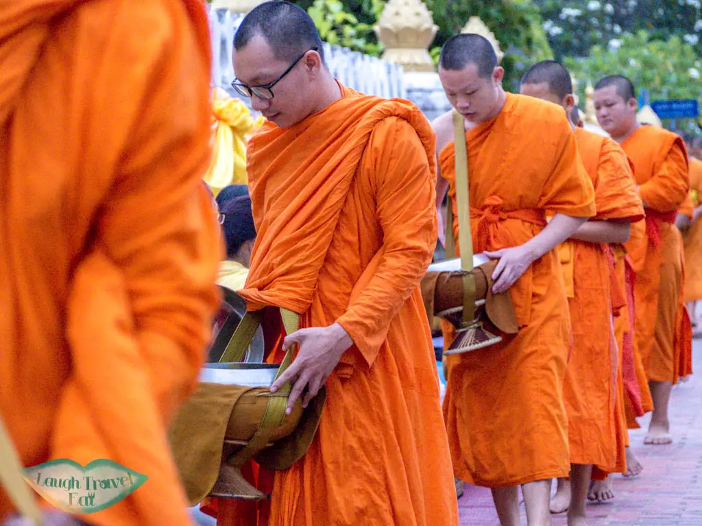 monks receiving alms luang prabang laos - laugh travel eat