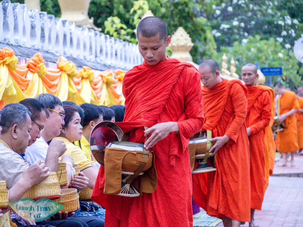 monks receiving alms luang prabang laos - laugh travel eat