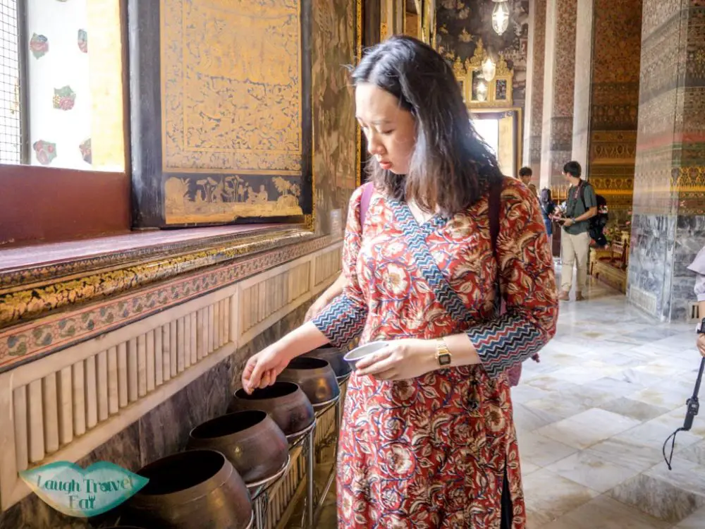 donating-money-to-bowls-wat-pho-bangkok-Thailand-laugh-travel-eat1