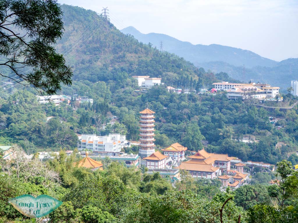 If you are seeking a dreamy hike without a crowd high up in the mountains, Wo Yang Shan is a long but worthwhile hike that’s perfect for an adventure. With giant rock outcrops, a view of Tai Mo Shan radar towers as well as the nearby cityscape and Shing Mun Reservoir, here is how to hike Tai Mo Shan: <!--TOC--> Wo Yang Shan summary Difficulty: 4/5 Duration: 6 hours (might want to budget more for photos) Pros: Not a crowded trail with spectacular view of Tai Mo Shan as well as Tsuen Wan and Tsing Yi. Cons: long hike up and back down can be tough on the knees. Also fairly long with several part that’s easy to get lost in. it would be best to have an offline map handy. How to get to Wo Yang Shan trail start Take the exit A3 from Tsuen Wan MTR station towards Discovery Park via the long pedestrian bridge. Enroute there you’ll see a bridge that goes towards the mountain, take it. From there, follow the path through the tunnel and then up some stairs to the main road. Cross the main road and go left (the stairs across the road isn’t the one we want to take). Wait until you reach this one, which has a sign a few more steps up declaring that it goes up to Fu Yung Shan. This portion has a stretch of almost endless stairs, but once you reach the top the path evens out for a good while before it’s time to head up again. Some more distinctive structures along the way are the black and yellow blocks to the side, which are decent for photos, one or two pavilions, as well as the view of Western Monastery. Once you reach a dam-like structure, take the stairs that goes up just after it. There is a sign that points to Lung Mun Country Trail and Chuen Lun. Go up the trail and when you reach this sign, go left to the side marked Chuen Lun then take the trail to the right a few paces to the Lead Mine Pass. This part also has a lot of stairs but of mud and wood, then it becomes a slope. The bulk of it is over once you emerge from the vegetation. Be careful of the last slope up to the first view point, aka the nearest crest we see. It’s fairly loose and slippery. Wo Yang Shan viewpoint If you have a drone, this is a good place to take it out for a spin, but do be careful of the transformers a little distance in front which could potentially disrupt the signal. Here, you can also see the radar towers at Tai Mo Shan, too, which we will be heading towards but won’t be actually going pass. To get to Wo Yang Shan, we carry on up to the mountains we see at the back. When you get up, head towards the sign that says danger, do not past to the front left and don’t turn right. This part of the trail is also very slippery, which is why it’s easier to go up than to go down. The top shares a similar view to the first view point, so if you want to take photos and or fly your drone here, it’s good, too. As you carry on up, there are several more giant rock outcrop that’s great for photos with the city and Shing Mun Reservoir in the background. On a good day, the Lion Rock Mountain is visible too. Do look at the time as you take photos as it’s easy to get carried away with all the photo opportunity here. Continue the path up and meander your way through the giant boulders, with the Tai Mo Shan Weather Radar directly in front. The rocks slowly become replaced by ankle high grass then by hedges that are taller than me. Keep an eye out here and make sure you stay parallel to the Tai Mo Shan Radar towers and not head south too early. It’s a longish hike through the hedges and paths, crossing two streams before reaching the Tai Mo Shan Fire Lookout at Miu Ko Toi. Here, the path drop down quite steeply but also offer a stunning panorama. I needed a knee brace to help with the descent but overall it’s not as slippery as I thought. Once you go down two big slopes, watch out for a path to the right that will take you to Chuen Lung, marked by white ribbons hung on tree branch. Here, it’s best to have a map (I use OSMAnd which is free) to make sure you are in the right place. The direct route is steeper, so look out for one that’s hidden in the vegetation: The route goes almost straight to Chuen Lung, so just stay on the track as it go steeply down. It briefly intersects with a big path but carry on straight down. The last stretch sees a small bamboo forest before we emerge next to someone’s house. How to get out We ended the hike at Cheun Lung and got the minibus at the end of the village back to Tsuen Wan. There is only one minibus number 80 and we took it to the end stop to go back to the MTR. Once you get off, head towards the small lane by the 7-11 and then take a right and go up the escalator. Just carry on straight from the pedestrian bridge and you’ll reach the MTR station quickly.