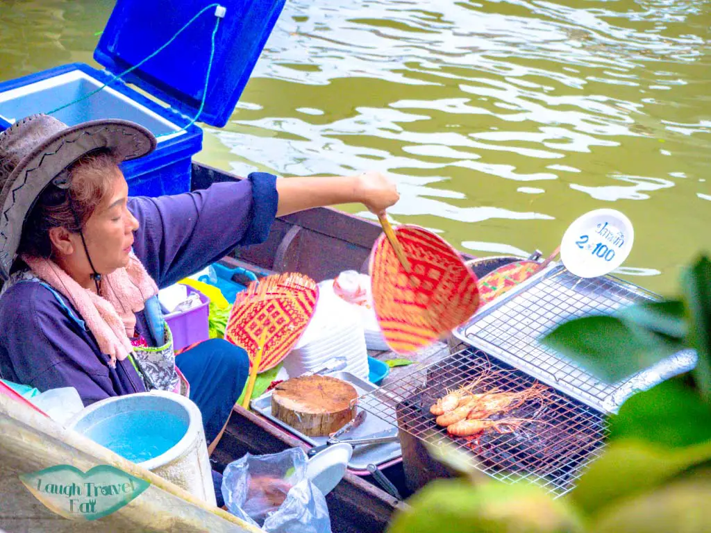 women-grilling-seafood-on-boat-at-amphawa-floating-market-bangkok-thailand-laugh-travel-eat