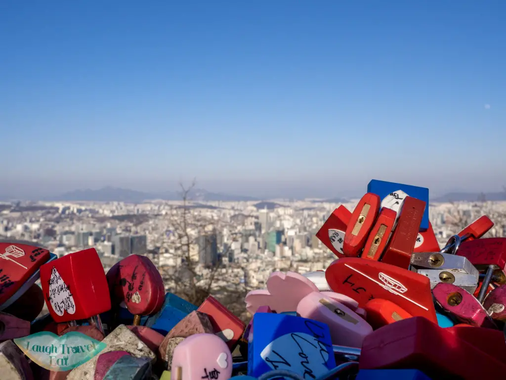 heart-locks-on-fence-namsan-tower-seoul-south-korea-laugh-travel-eat