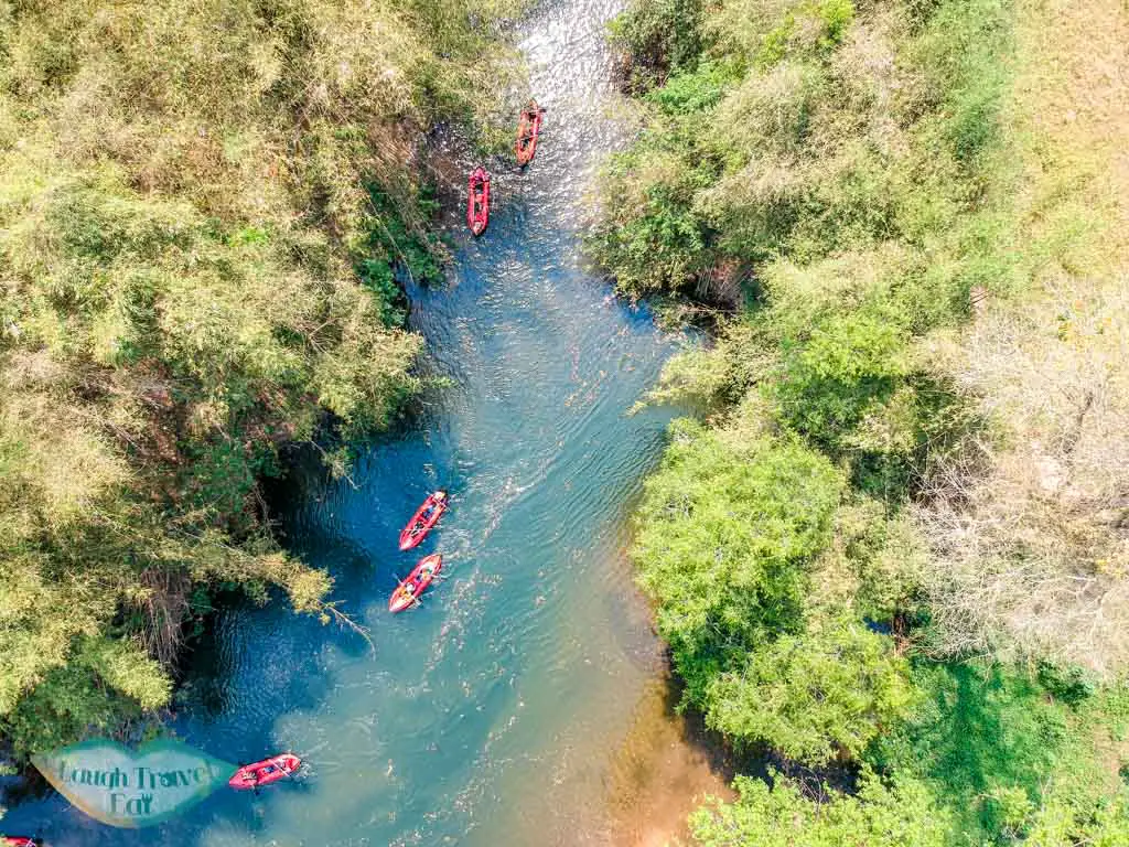 drone-shot-of-kayaking-on-nam-ha-river-nam-ha-national-park-luang-namtha-laos-laugh-travel-eat