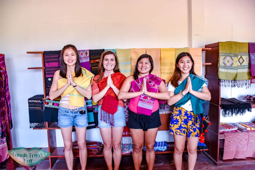 trying-the-scarves-on-at-Phieng-Ngam-Handicraft-center-luang-namtha-laos-laugh-travel-eat