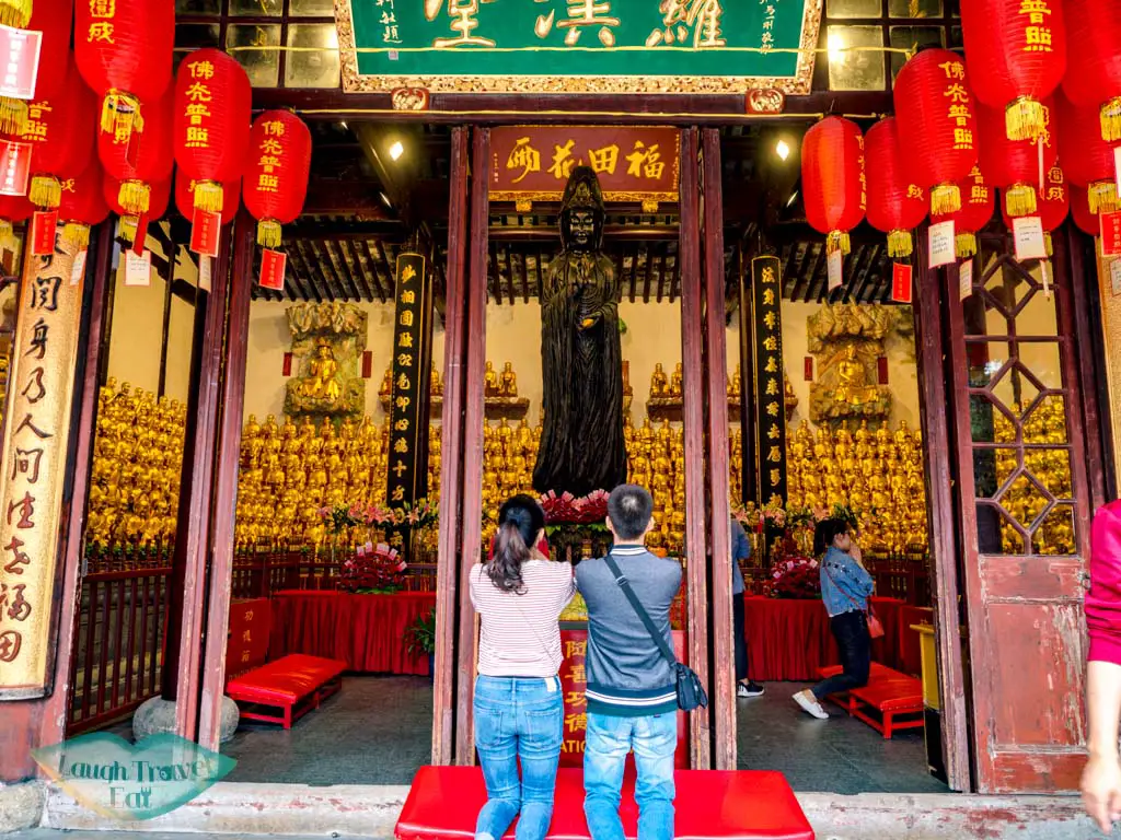 praying inside Longhua temple shanghai china