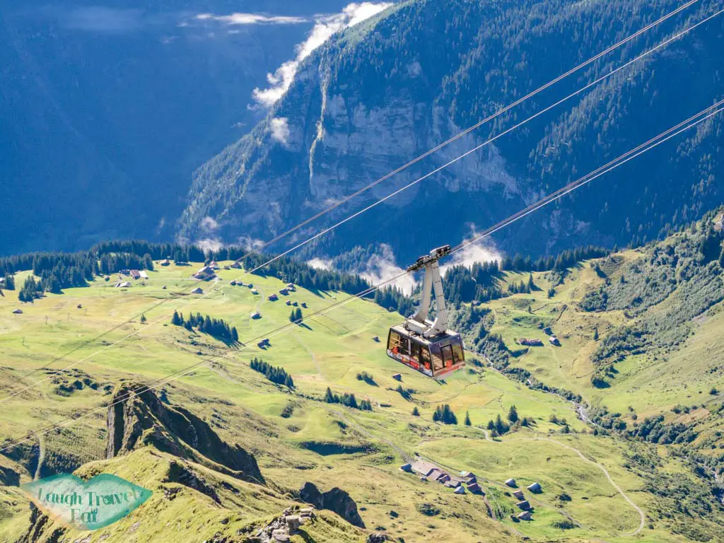 cable car going up and down schilthorn switzerland - laugh travel eat