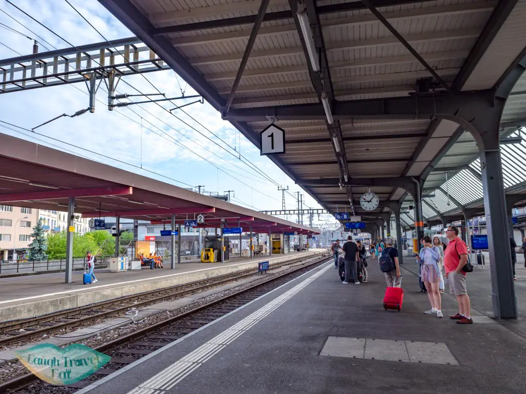 geneva train station platform switzerland - laugh travel eat