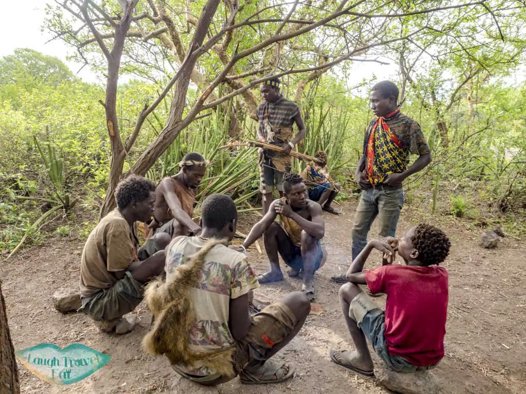 men gathering hadazan village tanzania africa - laugh travel eat