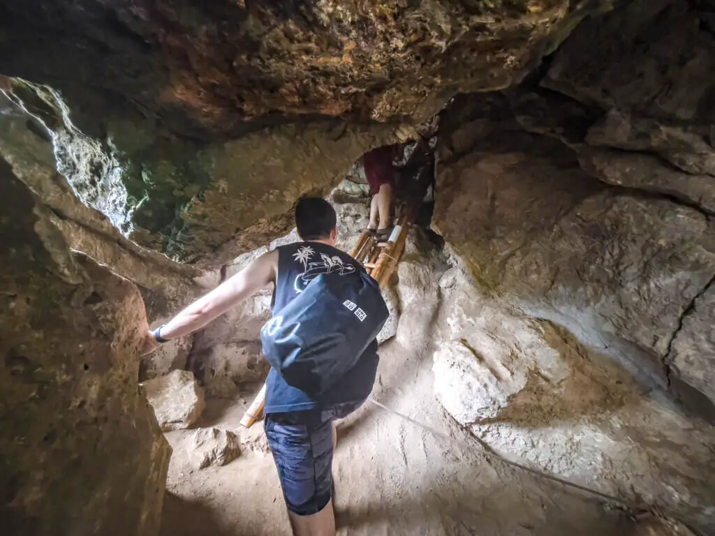 climbing up bat cave rock climbing railey krabi thailand - laugh travel eat-2
