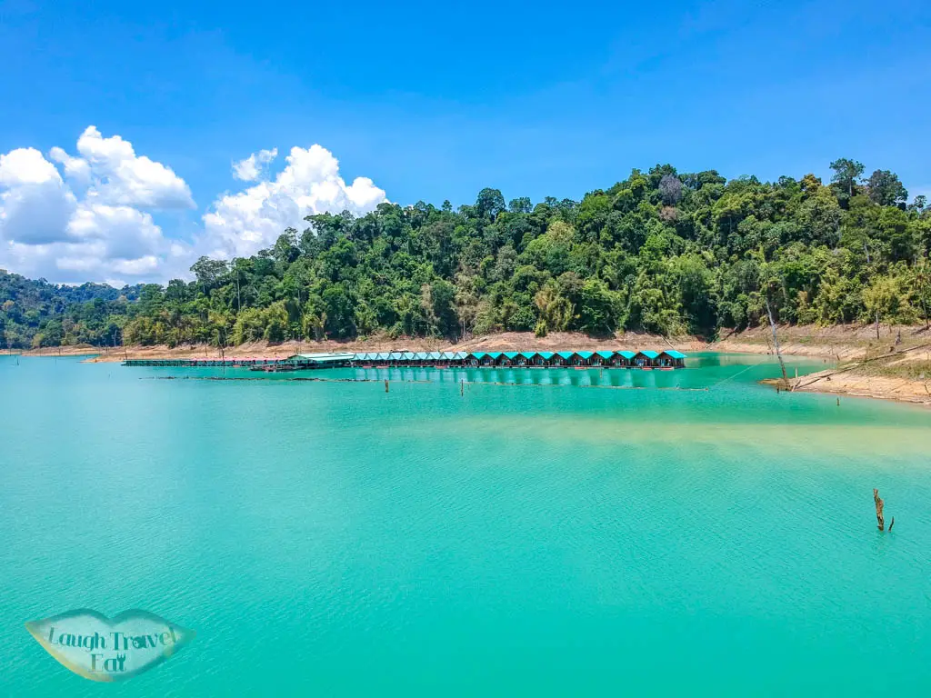 drone shot smiley lake house cheow lan lake khao sok thailand - laugh travel eat