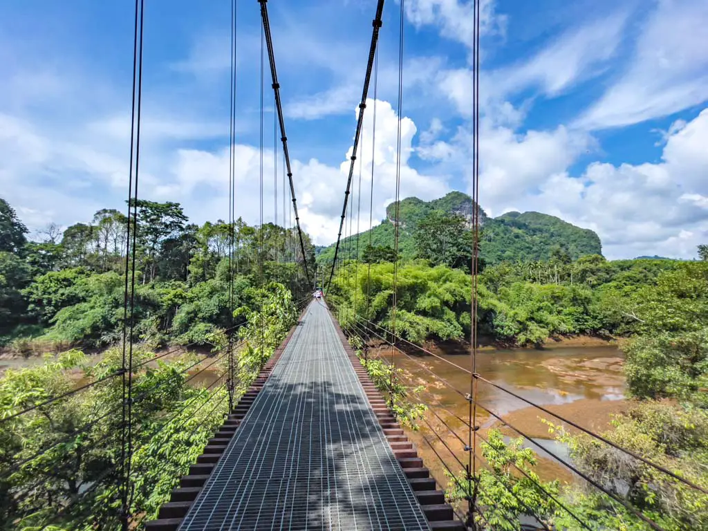 hanging bridge and heart shaped mountain cheow lan lake khao sok thailand - laugh travel eat
