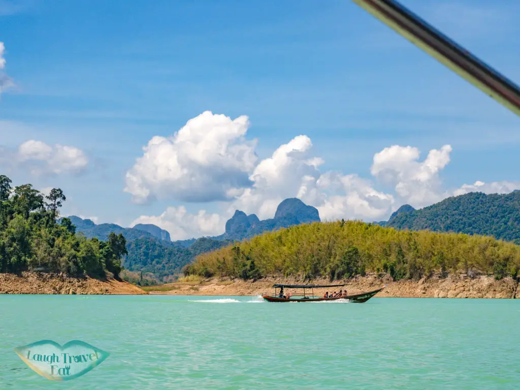 longtail boat to smiley lake house cheow lan lake khao sok thailand - laugh travel eat