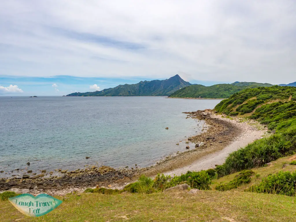 grass field and sharp peak from grass island sai kung hong kong - laugh travel eat