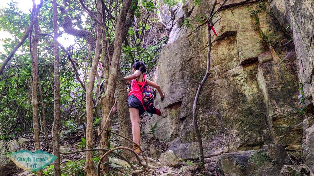 getting out of open book cliff pak lung stream lantau island hong kong - laugh travel eat
