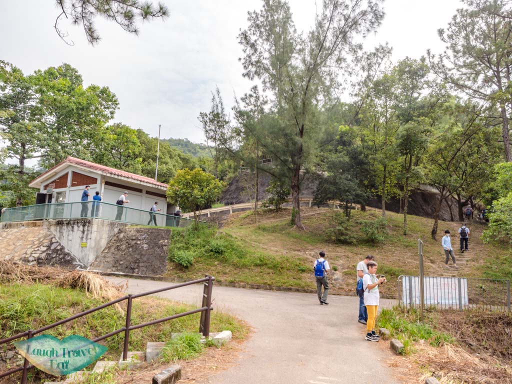 dam to tree lined walkway Lau Shui Heung Reservoir from main road new territories hong kong - laugh travel eat