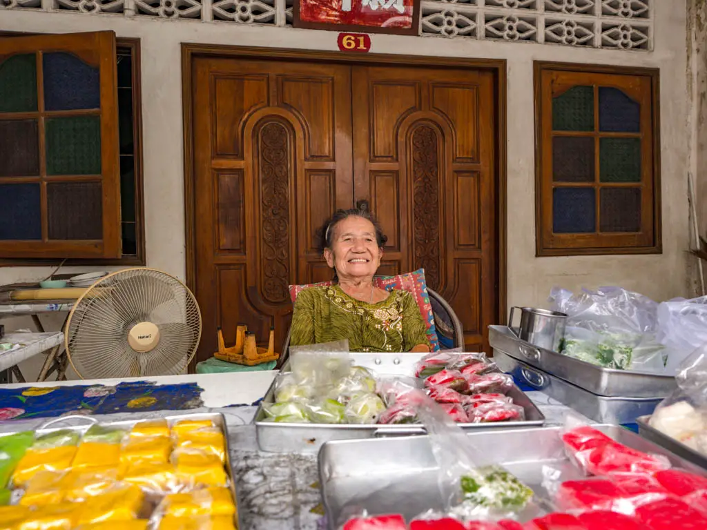 old lady selling traditional sweets a chefs tour southern flavours phuket town thailand laugh travel eat