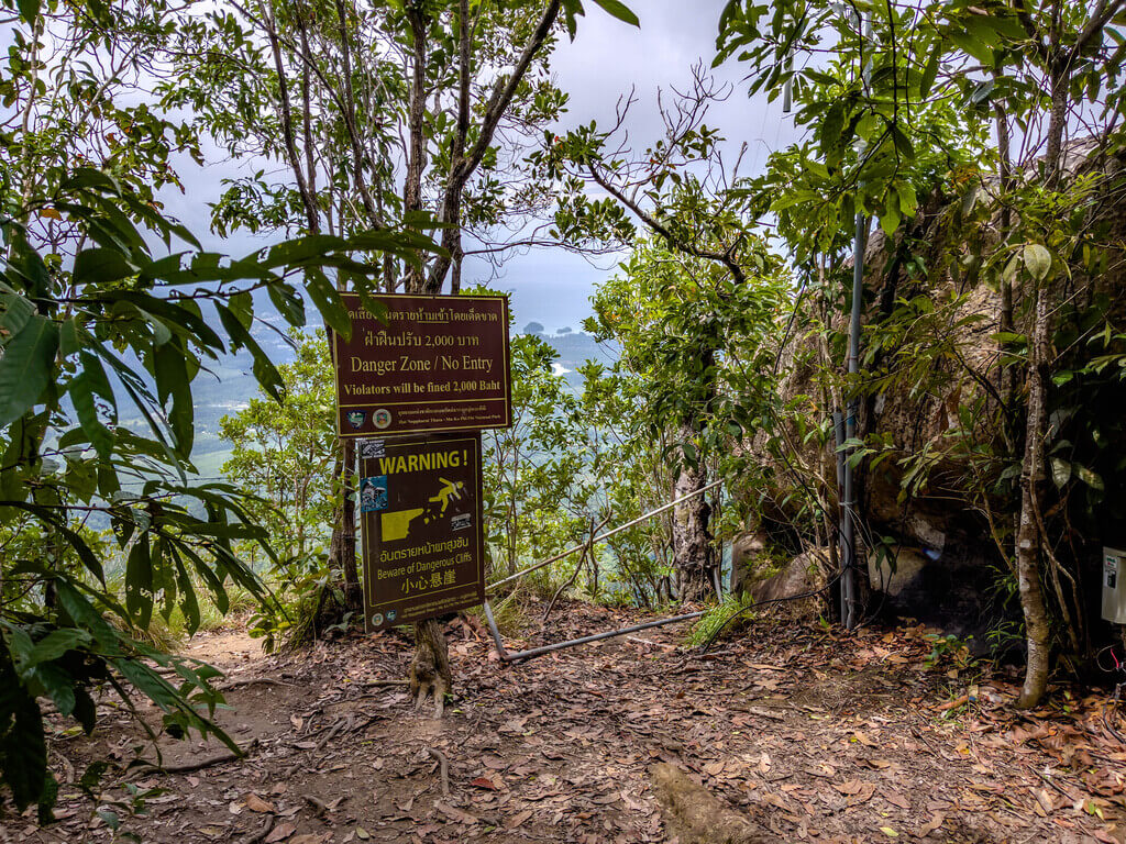 danger sign in front of instagram famous ledge Dragon Crest Mountain Khao Ngon Nak Krabi thailand - laugh travel eat