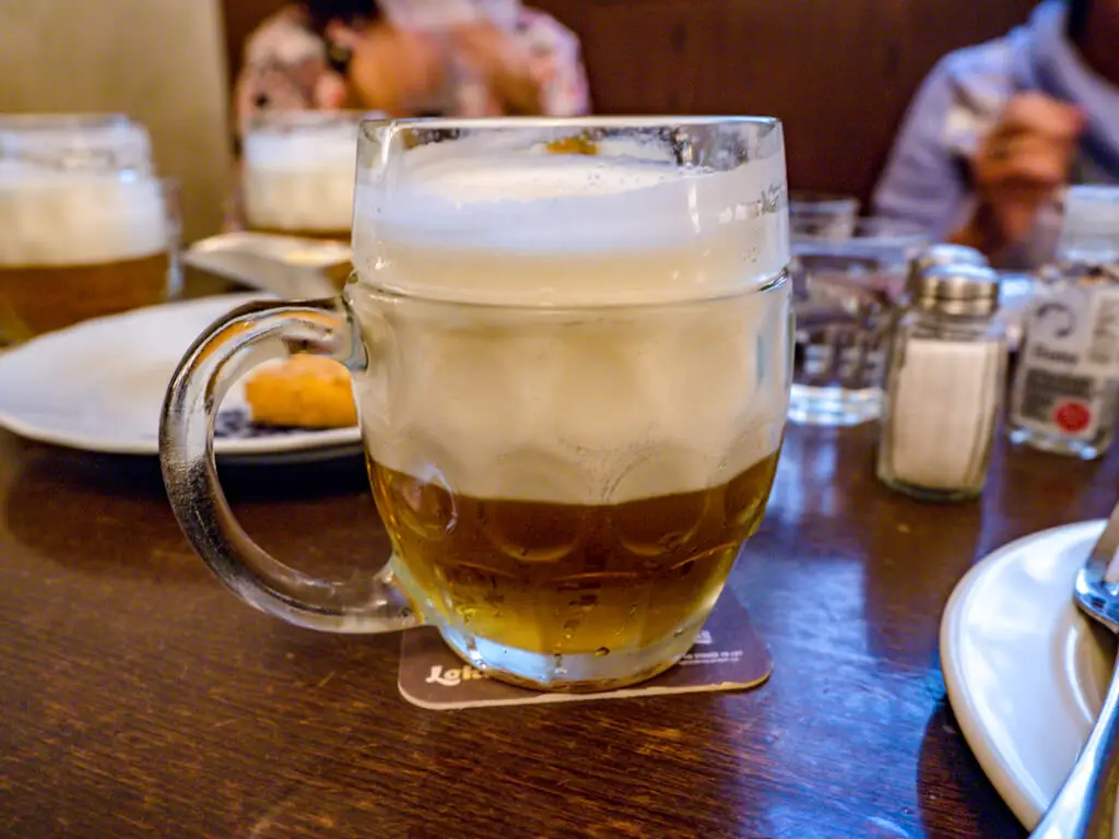foamy beer beer hall Food tour in Prague Hungary - laugh travel eat