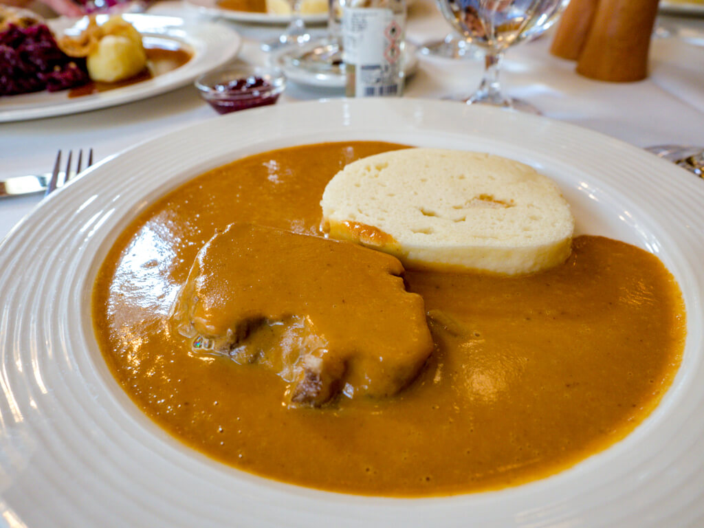 traditional beef with gravy and bread dumpling Food tour in Prague Hungary - laugh travel eat