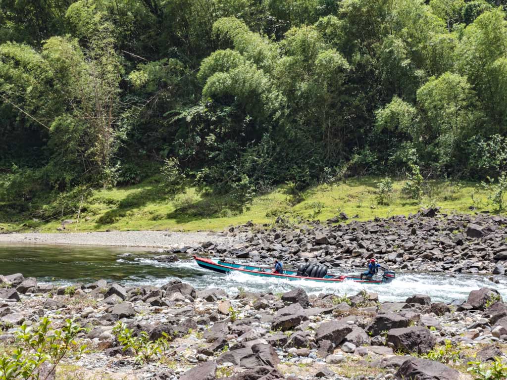 speedboat going up rapids river tubing near Suva Fiji - laugh travel eat
