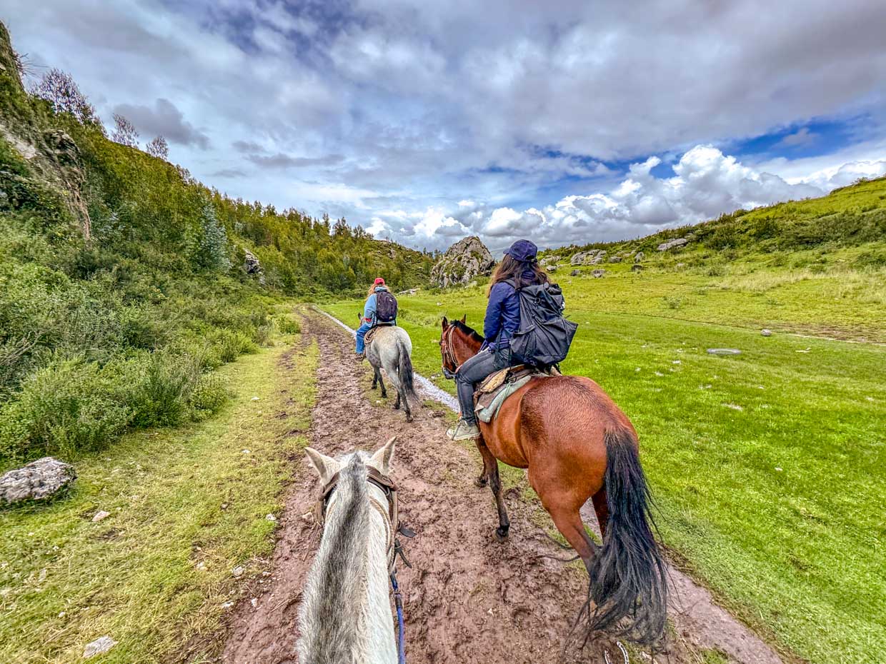 horse riding around ruins in Cusco Peru - laugh travel eat